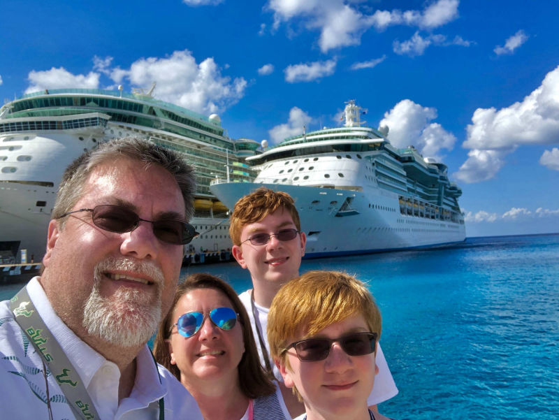 A Photo of David Brodosi and his family standing next to a cruise ship